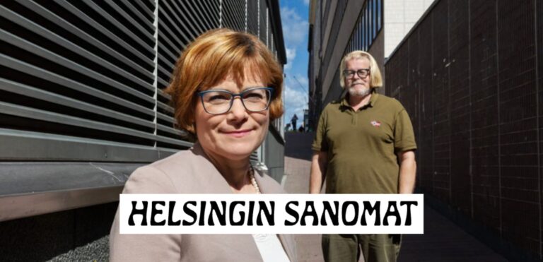 Oikeustieteen professori Anna Nylund (edessä) ja lakitoimisto Takaisinperinnän toimitusjohtaja Olli-Matti Korhonen (takana) seisovat ulkona rakennusten välissä. Nylund hymyilee kameraan, Korhonen katsoo eteenpäin.
